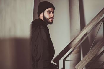 A potential burglar lurks around a staircase