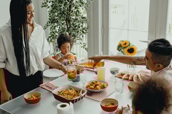 A family enjoys a meal at home