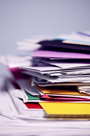 A messy stack of insurance documents