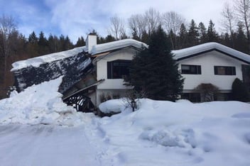 A home in the middle of winter, damaged by extreme weather