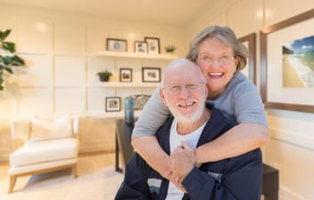 An elderly couple in their home