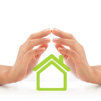 A pair of hands cover a small image of a home, representing the help of a Public Adjuster