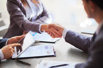 A public adjuster meets with a client in an office