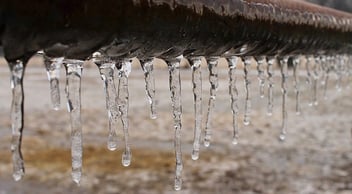 A frozen pipe covered in icicles