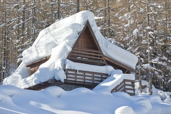 A home is covered with dangerous amounts of snow and ice.