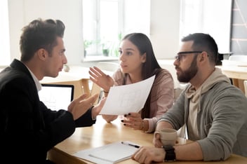 An insurance agent argues with clients about their plan
