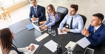 A man is examined by lawyers at a meeting