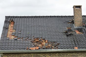 A roof with torn out shingles in Jupiter