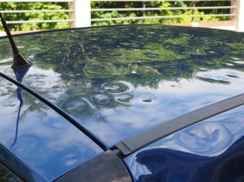 A car in Southern Florida is dented after a hail storm.