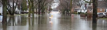 Flood waters ravage a residential neighborhood.