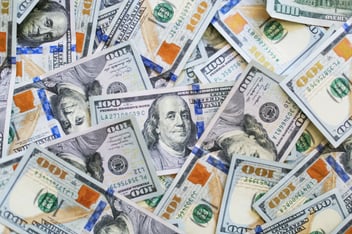 A pile of one hundred dollar bills from an insurance bonus