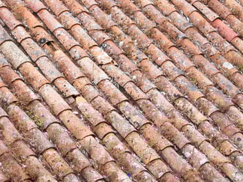 Heavily damaged clay roof tiles after a hurricane