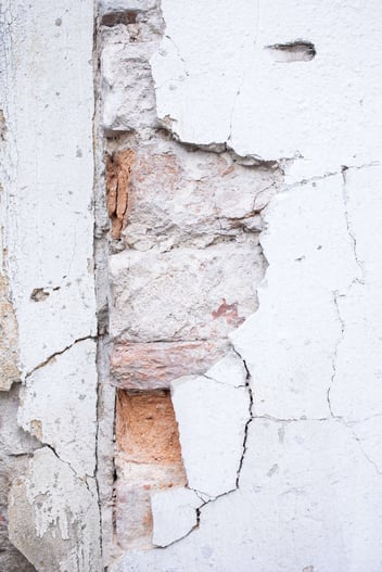 A close up image of a damage Stucco wall