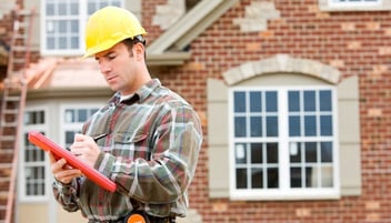 A public adjuster inspects a home for damages