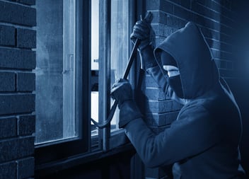 A burglar makes his entrance into a home that is about to be robbed. 